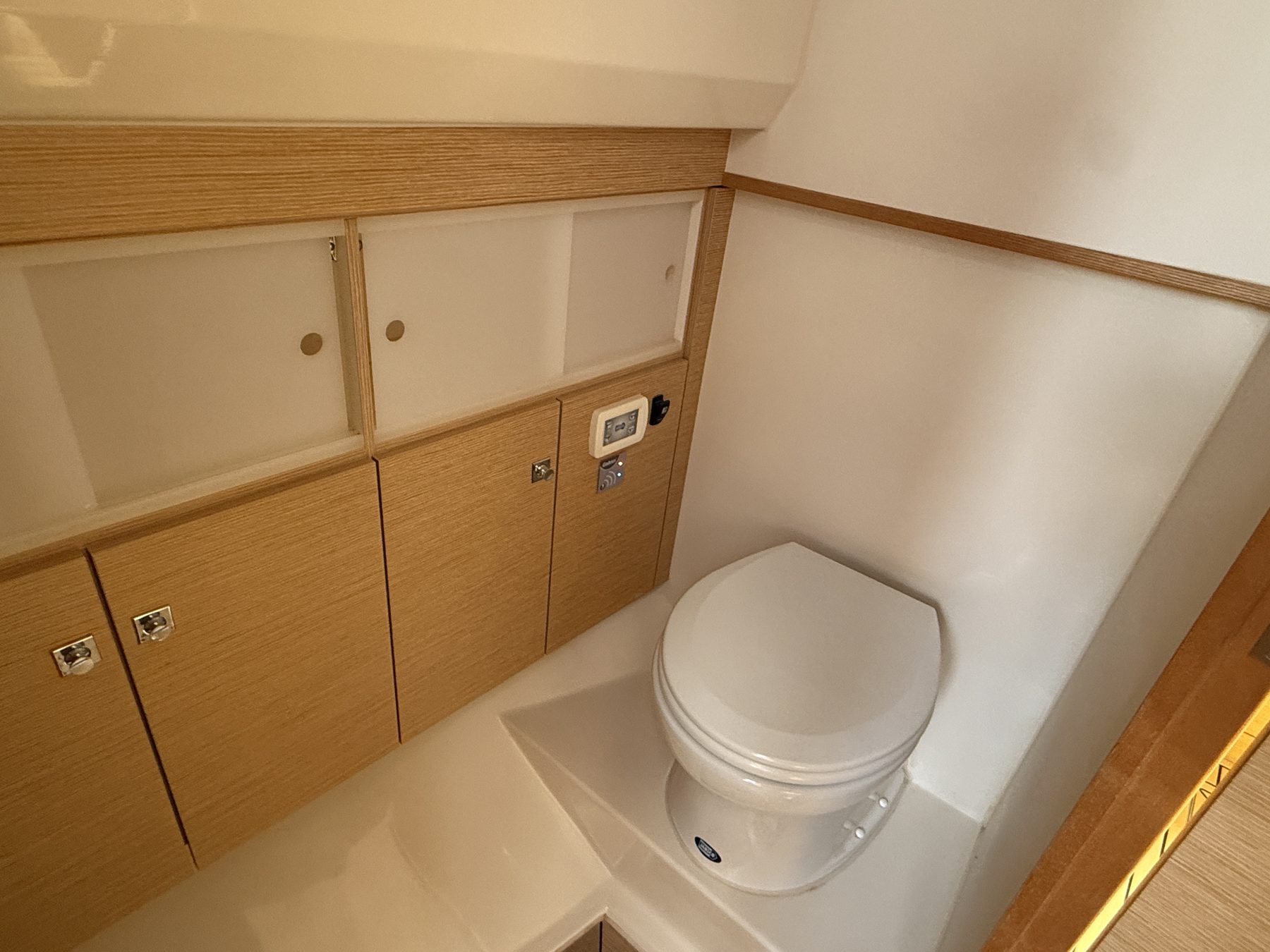 Head compartment with toilet and wood cabinetry